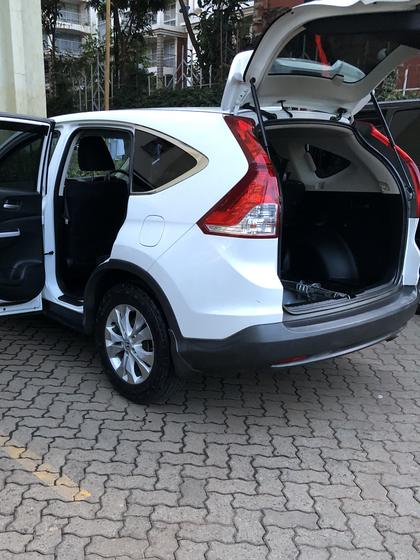 White Honda CR-V with all doors and the boot open during a detail