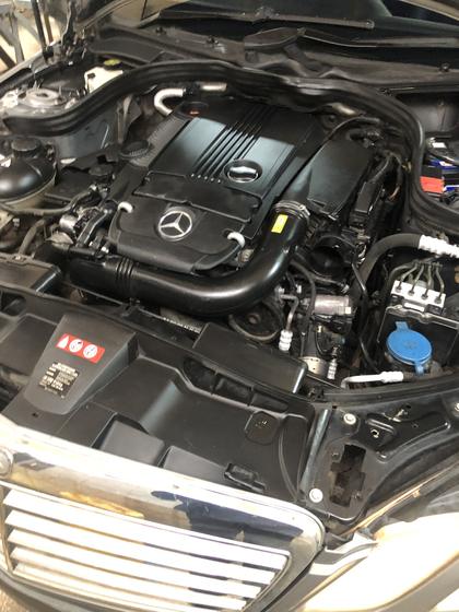 Clean, dressed engine bay of a Mercedes-Benz saloon with the bonnet open