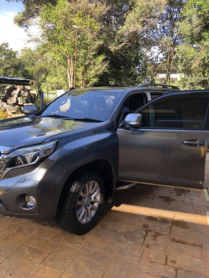 Grey Toyota Prado gleaming in a garden driveway after a full detail
