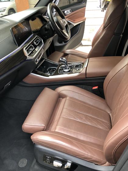 Clean brown leather front seats inside a BMW X5